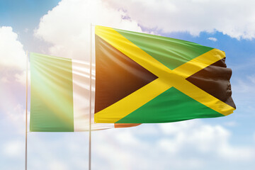 Sunny blue sky and flags of jamaica and ireland