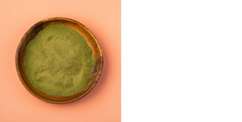Organic green powder in the wooden bowl - Moringa