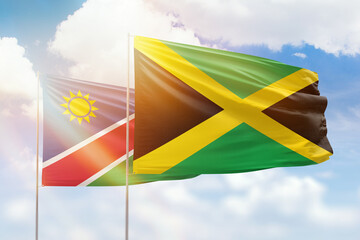 Sunny blue sky and flags of jamaica and namibia