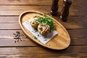 Baked potatoes with cheese on a tray
