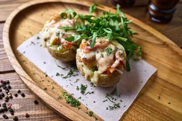 Baked potatoes with cheese on a tray