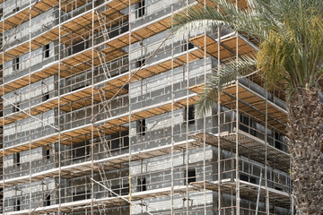 Scaffolding on the construction site in Israel. Modern Apartments Architecture Building infrastructure concept.