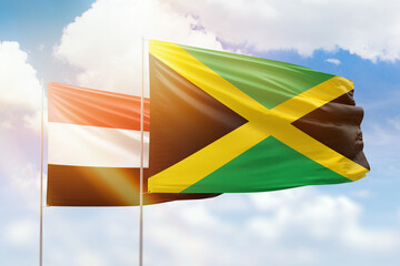 Sunny blue sky and flags of jamaica and yemen