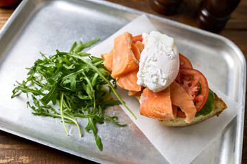 Sandwich with fish and egg on a tray