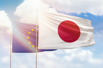 Sunny blue sky and flags of japan and european union