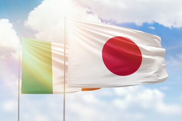 Sunny blue sky and flags of japan and ireland