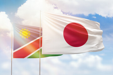 Sunny blue sky and flags of japan and namibia