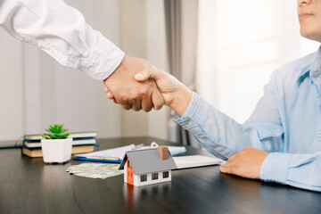 Buyer and seller shake hands and Real estate brokers or real estate agent with client or architect team Discussions about contracts , Business property Concept.