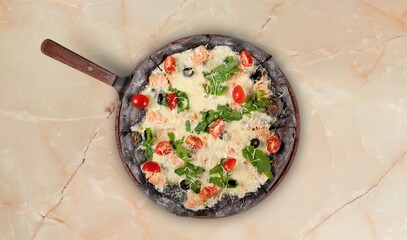 Sliced spicy tasty pizza with onion on a rustic table.