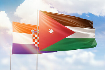 Sunny blue sky and flags of jordan and croatia