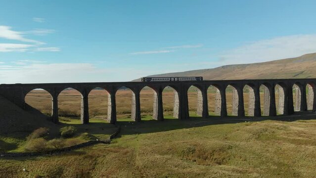 Aerial view of the train going accross Ribblehead viaduct, North Yorkshire, UK
