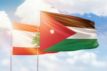 Sunny blue sky and flags of jordan and lebanon