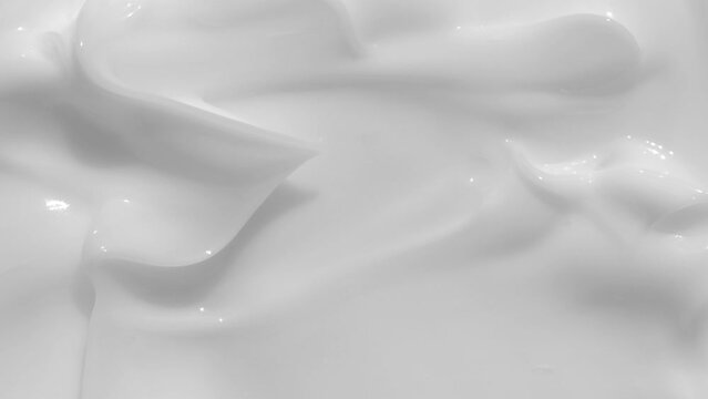 White light creamy cosmetic beauty product smudge swipe closeup video. Moisturising creme swatch motion with spatula. Skincare cosmetics lotion mousse product close up footage. Macro. 