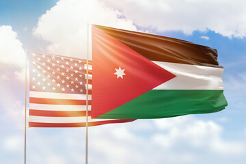 Sunny blue sky and flags of jordan and usa