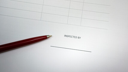 The inspection person signing area line of the document paper form with a luxury ballpoint pen...
