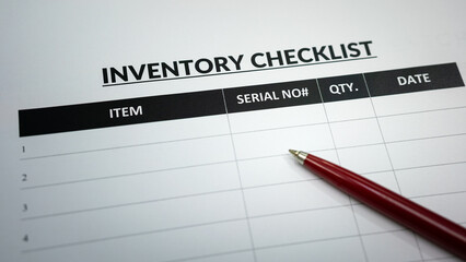 A blank form of storage inventory checklist table with luxury ballpoint pen placed on it. Business...