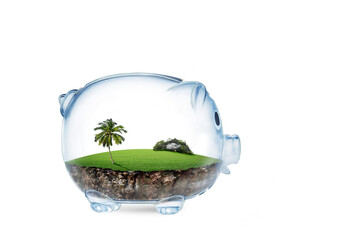 Saving to buy a land or land savings concept with grass growing in shape of land inside transparent...