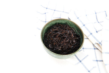 Hijiki seaweed in ceramic bowl on white background. Japanese food