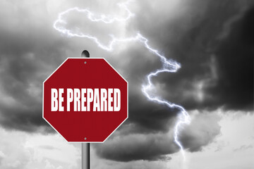 Be Prepared text on a red stop sign with a dangerous storm and lightning in the background.
