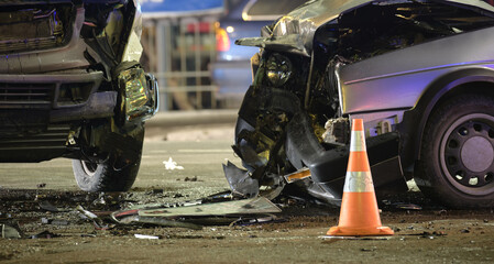 Cars crashed heavily in road accident after collision on city street at night. Road safety and...