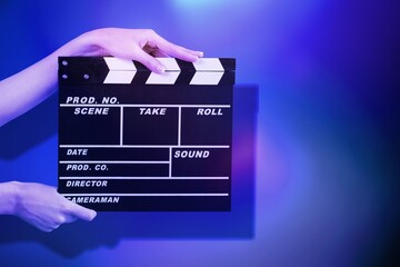 Classic movie slate or clapper board. Empty film making clapperboard on color background