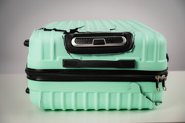 Mint damaged suitcase on a white background.