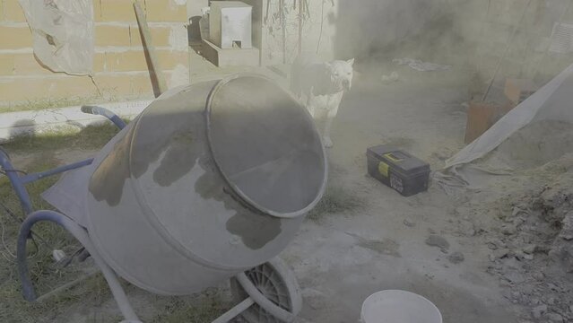 South American builder preparing mortar mixture in mortar construction electric