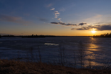 Evening Sunset over a Partially Frozen Lake