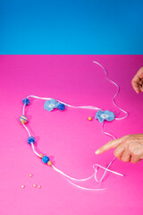 The female hands of the master assemble a handmade product from felted wool