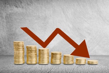 Stack of coins bar chart and graph trending downwards. Economy recession crisis, inflation,...