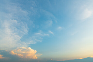 Twilight blue bright and orange yellow dramatic sunset sky in countryside or beach colorful cloudscape texture with white clouds air background.
