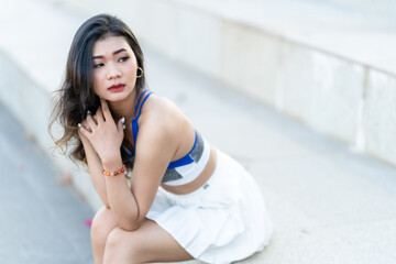 Portrait of beautiful athletic young asian woman in fashionable sportswear standing and having rest after strong exercise training in garden the park,Outdoor Sporty concept