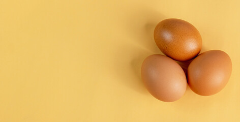 Eggs are laid in groups of three, eggshells with different patterns. Shot in a studio with light and shadows against an eggshell colored background.