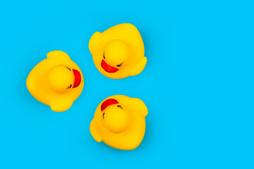 Rubber toy ducklings on a blue background.