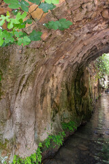 Tunnel  pierced in the mountain by a mountain river in a Hermon Stream Nature Reserve in northern Israel