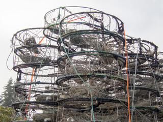Stacks of crab pots against an overcast sky