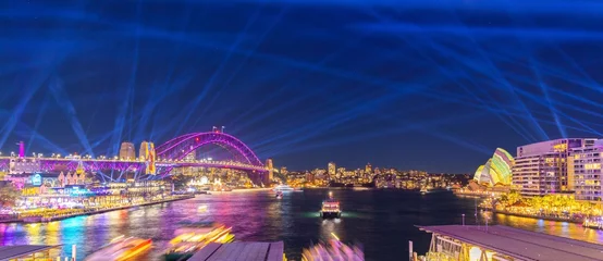 Zelfklevend Fotobehang Colourful Light show at night on Sydney Harbour NSW Australia. The bridge illuminated with lasers and neon coloured lights  © Elias Bitar