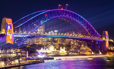 Plakat Colourful Light show at night on Sydney Harbour NSW Australia. The bridge illuminated with lasers and neon coloured lights 