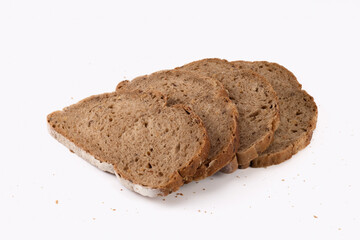 Slices of bread with crumbs isolated on bright background. Wholegrain bread. Close up view.
