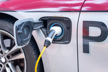 Thailand police electric car (EV) charging battery. Environmental protection concept. Selective...