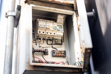 Old open electrical control panel box. Selective focus