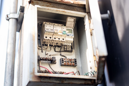 Old open electrical control panel box. Selective focus