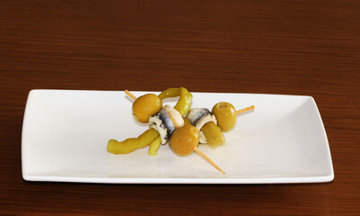 Typical Spanish food, tapas, prepared with olives, anchovies, and peppers