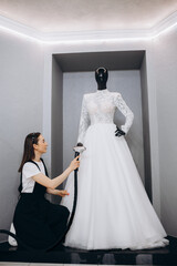 Women Ironing wedding dress in studio by Ironing machine. Wedding concept.