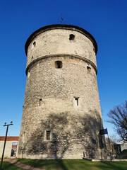 Fototapeta na wymiar Artillery tower Kik-in-de-Kök of the medieval defensive wall of the city of Tallinn against the blue sky.