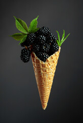 Fresh blackberries in a waffle cone.