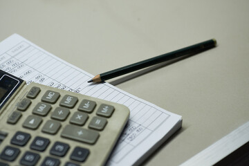 Close-up of a calculator with financial figures and a pencil - stock photo