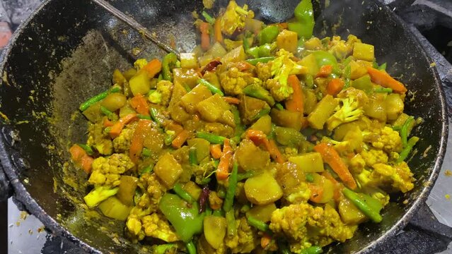Veg fried for preparing Khichdi. Indian vegetable curry dish. Vegetarian Asian food and meal.