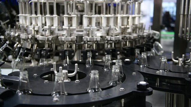 Clear glass bottles transfer on Automated conveyor systems industrial automation for package