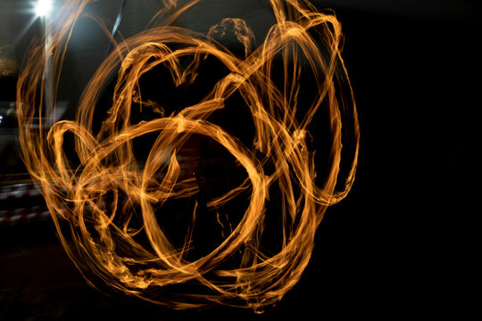 Circles of fire. Lines of flame. Shooting fire show on long shutter speed.